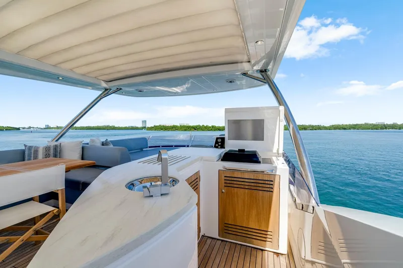  Yacht Photos Pics Luxurious 2021 Sunseeker 76 Yacht deck with seating, table, and ocean view.