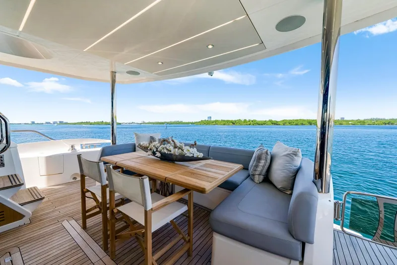  Yacht Photos Pics Luxurious Sunseeker 76 Yacht 2021 with elegant outdoor seating and scenic ocean view.