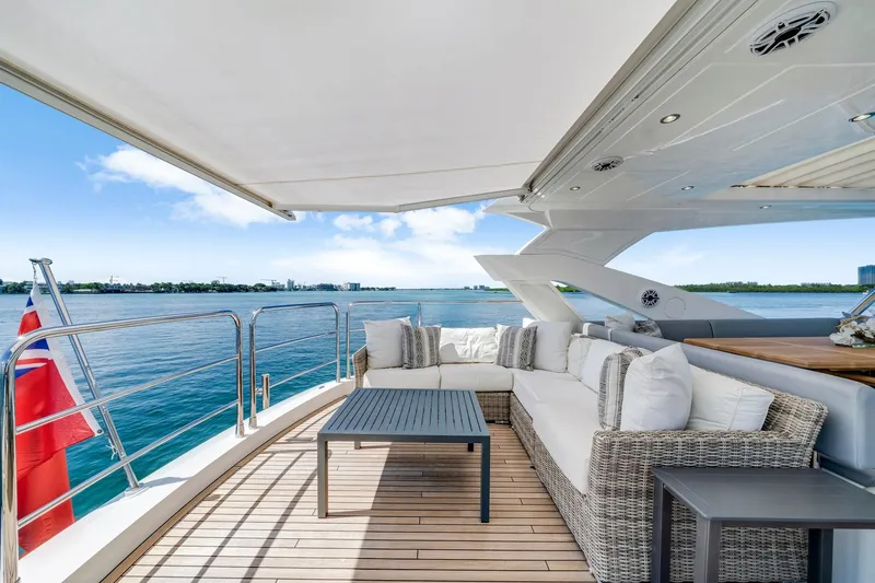 Yacht Photos Pics Luxurious Sunseeker 76 Yacht 2021 with elegant outdoor seating and ocean view.