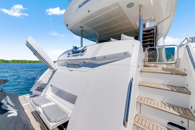  Yacht Photos Pics 2021 Sunseeker 76 Yacht with open deck, stairs, and scenic water view.