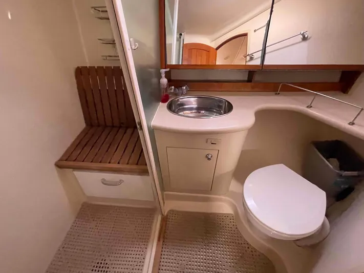 Sapphire Seas Yacht Photos Pics Bathroom interior of 2006 Hunter 45 Center Cockpit yacht, featuring sink, toilet, and wooden bench.