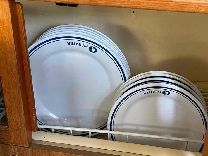 Sapphire Seas Yacht Photos Pics Plates with "Hunter" logo in a wooden cabinet, Hunter 45 Center Cockpit, 2006.