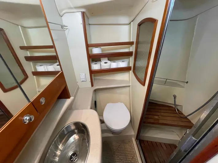 Sapphire Seas Yacht Photos Pics Bathroom interior of 2006 Hunter 45 Center Cockpit yacht with sink, toilet, and shower.