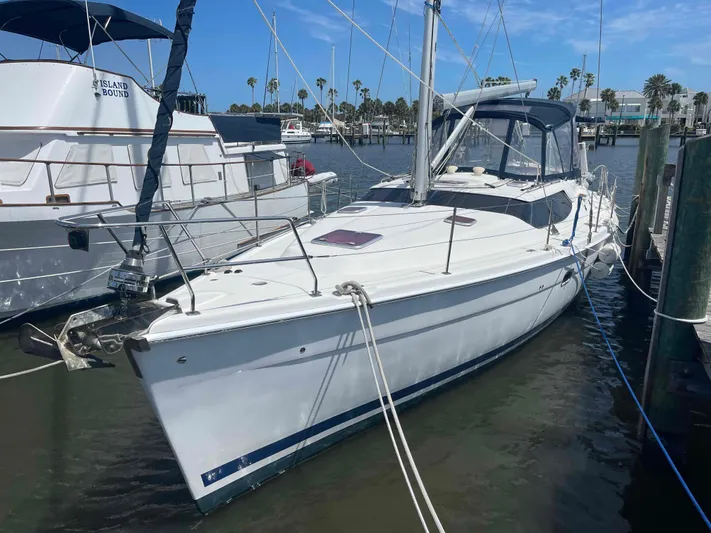 Sapphire Seas Yacht Photos Pics 2006 Hunter 45 Center Cockpit sailboat docked in a marina under a clear blue sky.