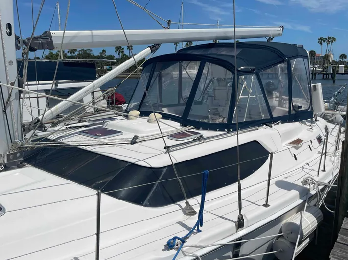 Sapphire Seas Yacht Photos Pics 2006 Hunter 45 Center Cockpit sailboat docked, featuring a sleek design and blue canopy.