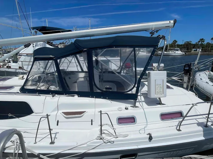 Sapphire Seas Yacht Photos Pics 2006 Hunter 45 Center Cockpit sailboat docked, featuring a blue canopy and sleek design.