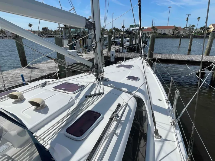 Sapphire Seas Yacht Photos Pics Sailboat docked at marina, 2006 Hunter 45 Center Cockpit, clear sky, calm water.