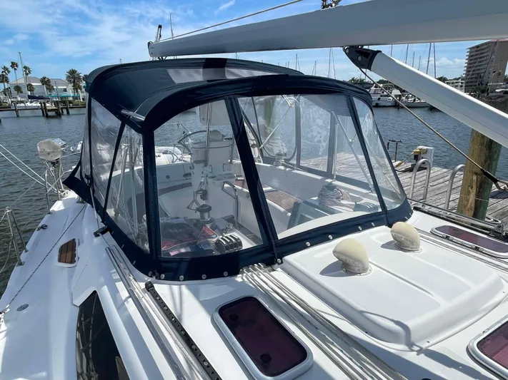 Sapphire Seas Yacht Photos Pics 2006 Hunter 45 Center Cockpit sailboat with covered cockpit, docked at marina.