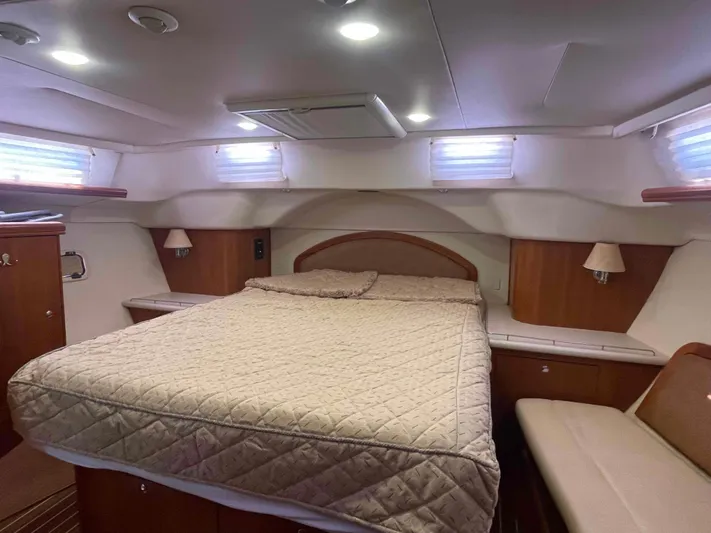 Sapphire Seas Yacht Photos Pics Luxurious cabin interior of 2006 Hunter 45 Center Cockpit yacht with cozy bed and ambient lighting.