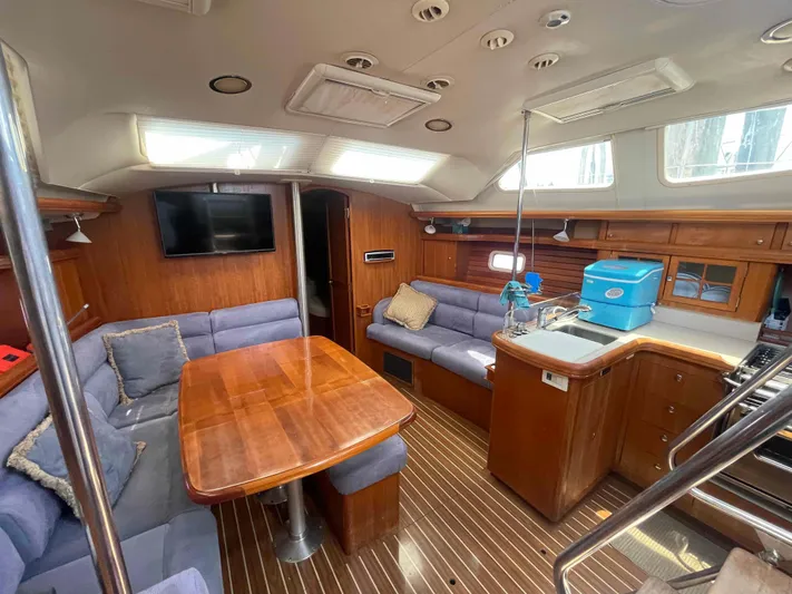 Sapphire Seas Yacht Photos Pics Luxurious interior of 2006 Hunter 45 Center Cockpit yacht with wood finishes and modern amenities.