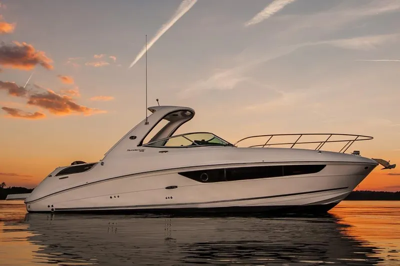 Luna Sea Yacht Photos Pics 2015 Sea Ray 310 Sundancer yacht at sunset on calm water.