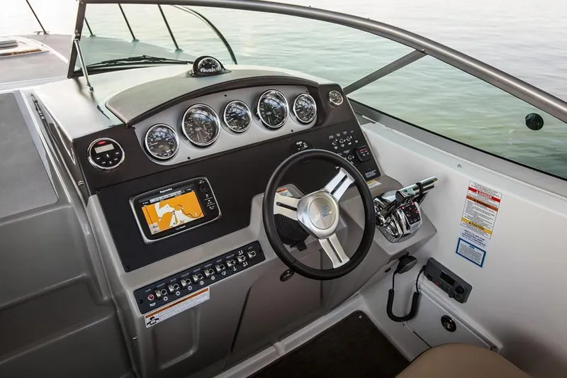 Luna Sea Yacht Photos Pics 2015 Sea Ray 310 Sundancer boat cockpit with steering wheel and navigation system.