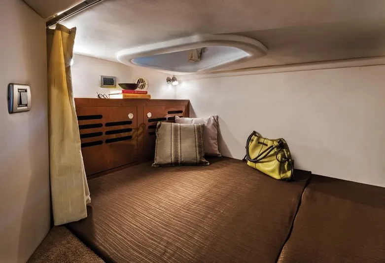 Luna Sea Yacht Photos Pics Cozy cabin interior of 2015 Sea Ray 310 Sundancer with bed, pillows, and storage.