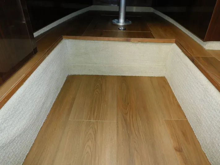 Luna Sea Yacht Photos Pics Interior flooring of 2015 Sea Ray 310 Sundancer boat, featuring wood and carpet design.