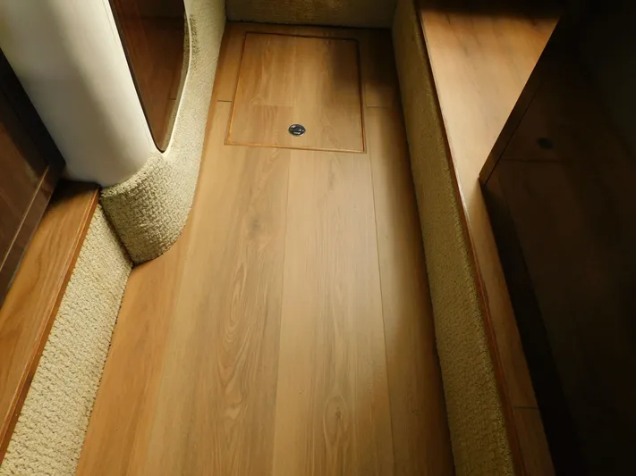 Luna Sea Yacht Photos Pics Interior view of 2015 Sea Ray 310 Sundancer with wood flooring and carpeted sides.