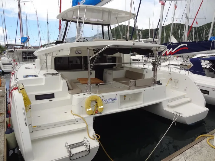 Shamwari Yacht Photos Pics 2020 Lagoon 46 catamaran docked at marina, featuring spacious deck and seating area.