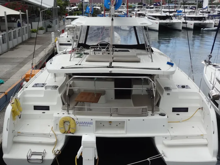 Shamwari Yacht Photos Pics 2020 Lagoon 46 catamaran docked at marina, featuring spacious deck and seating area.