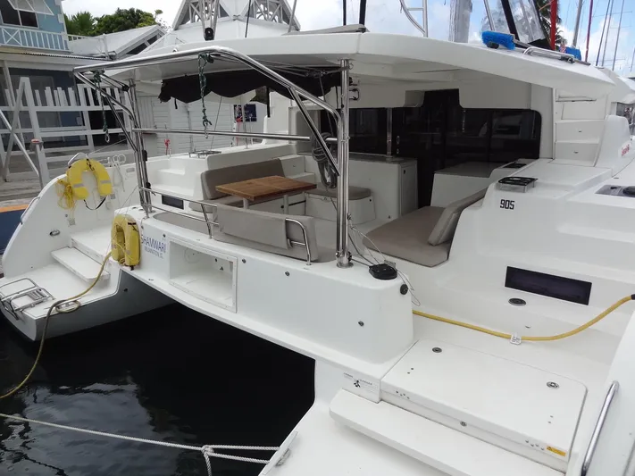 Shamwari Yacht Photos Pics 2020 Lagoon 46 catamaran with spacious deck and seating area, docked at marina.