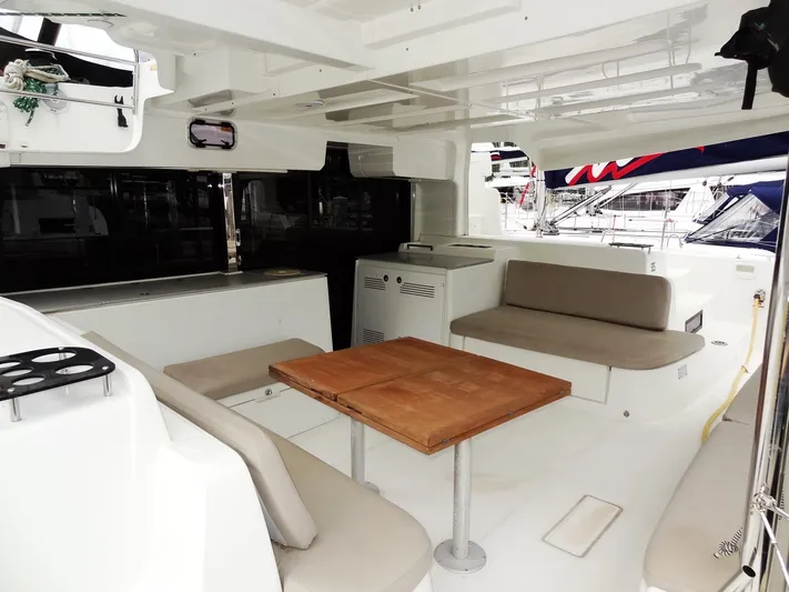 Shamwari Yacht Photos Pics Spacious 2020 Lagoon 46 yacht interior with seating and wooden table.