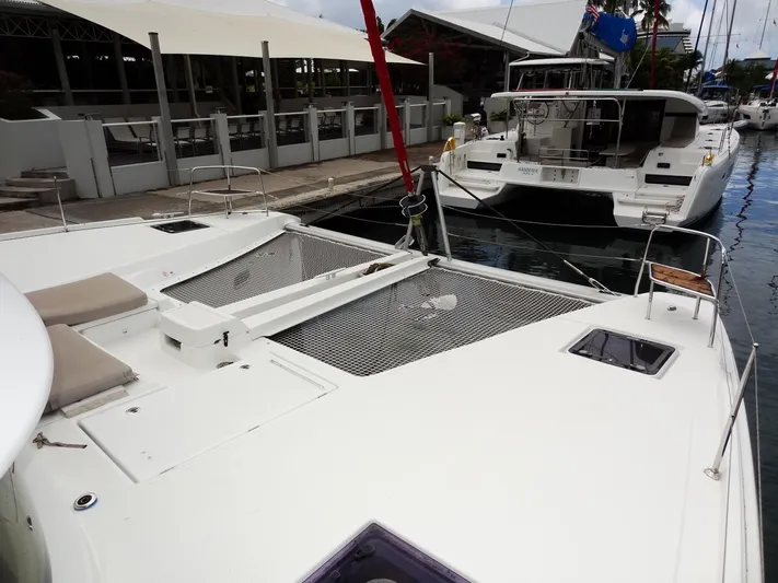 Shamwari Yacht Photos Pics 2020 Lagoon 46 catamaran docked at marina, showcasing spacious deck and netting.