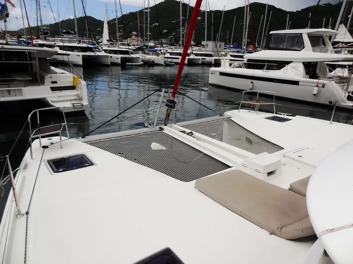 Shamwari Yacht Photos Pics 2020 Lagoon 46 catamaran docked in a marina with surrounding boats.