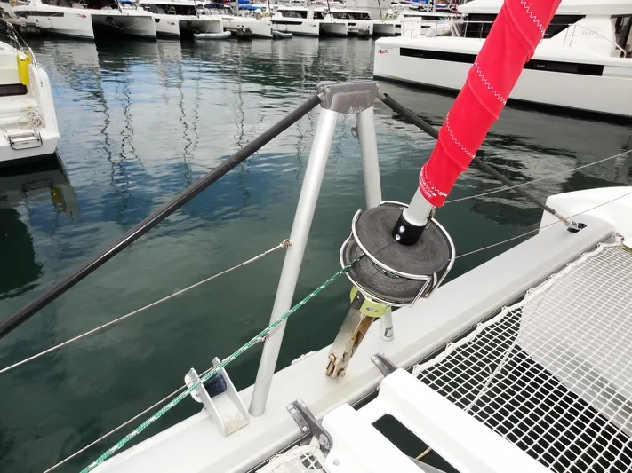 Shamwari Yacht Photos Pics 2020 Lagoon 46 catamaran bow with red sail, docked in marina.