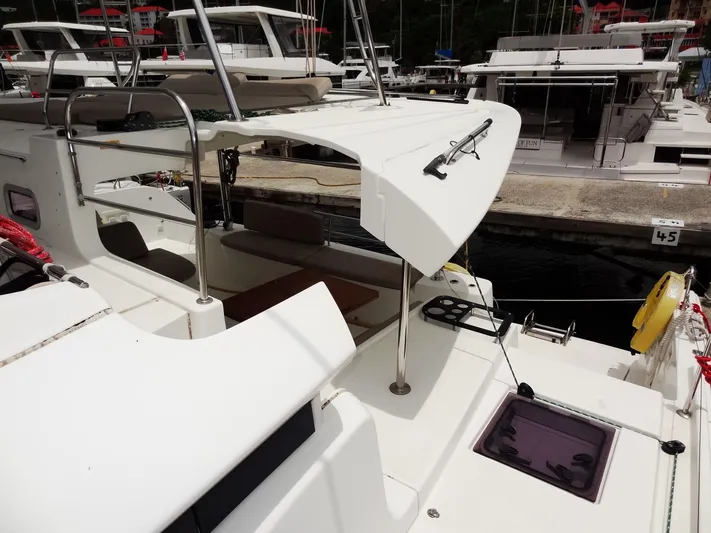 Shamwari Yacht Photos Pics 2020 Lagoon 46 catamaran docked at marina, showcasing deck and seating area.