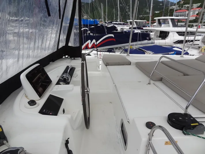 Shamwari Yacht Photos Pics 2020 Lagoon 46 catamaran helm station with navigation equipment and seating area.