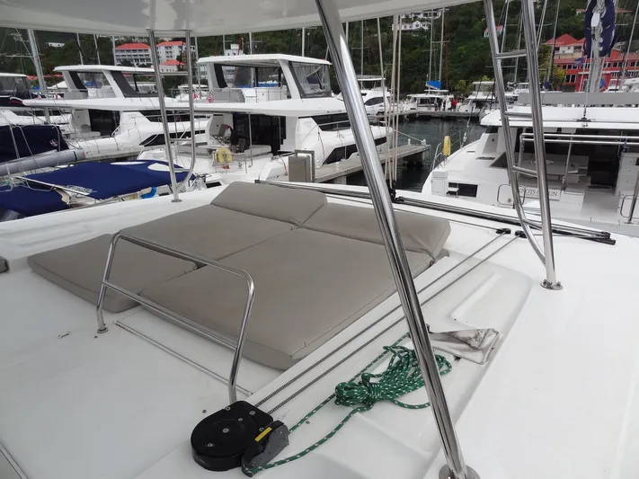 Shamwari Yacht Photos Pics Lagoon 46 catamaran deck with cushioned seating, docked in a marina, 2020 model.