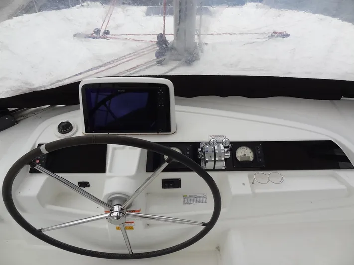 Shamwari Yacht Photos Pics Helm of 2020 Lagoon 46 catamaran with navigation equipment and steering wheel.