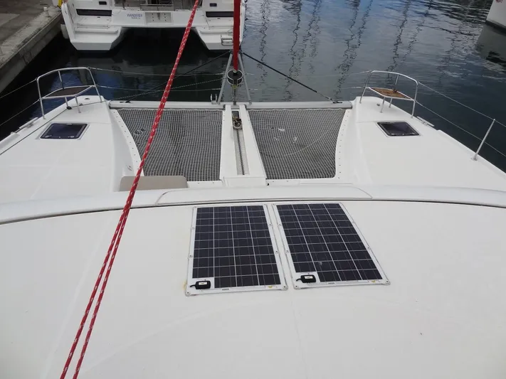 Shamwari Yacht Photos Pics 2020 Lagoon 46 catamaran with solar panels and netting on deck, docked at marina.