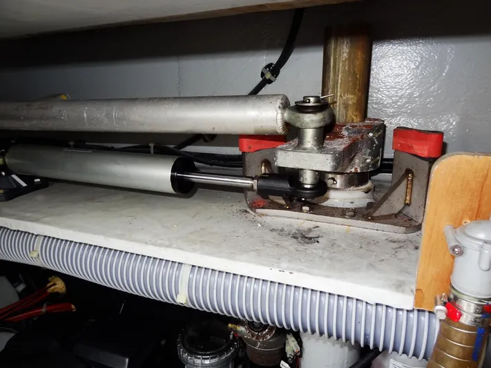 Shamwari Yacht Photos Pics Hydraulic steering mechanism of a 2020 Lagoon 46 catamaran, featuring metal components and tubing.