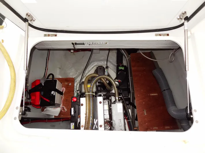 Shamwari Yacht Photos Pics Engine compartment of a 2020 Lagoon 46 catamaran, featuring mechanical components and storage.