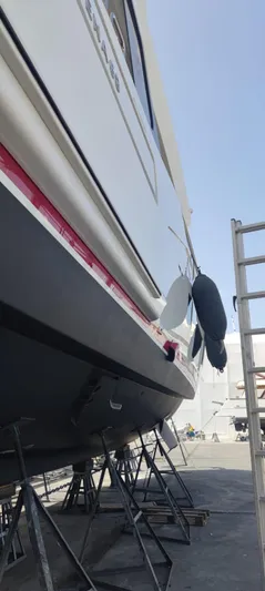  Yacht Photos Pics 2023 Sirena 68 yacht on stands, side view, under clear sky.