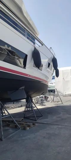  Yacht Photos Pics 2023 Sirena 68 yacht on dry dock, side view with fenders and supports.