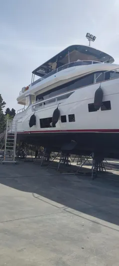  Yacht Photos Pics 2023 Sirena 68 yacht on dry dock, side view with visible fenders.