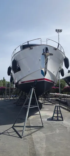  Yacht Photos Pics 2023 Sirena 68 yacht on dry dock, front view with clear sky background.
