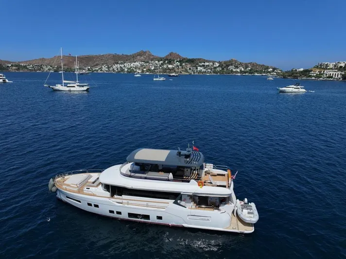  Yacht Photos Pics Luxurious 2023 Sirena 68 yacht cruising in a scenic bay with other boats.