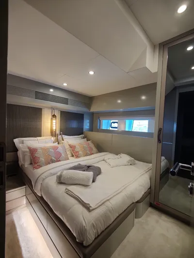  Yacht Photos Pics Luxurious bedroom interior of 2023 Sirena 68 yacht with modern design and cozy bedding.