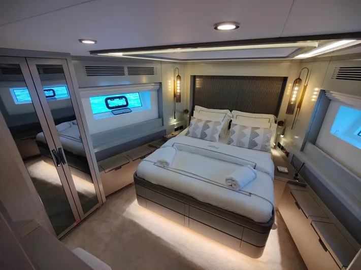  Yacht Photos Pics Luxurious bedroom interior of 2023 Sirena 68 yacht with modern design and ambient lighting.