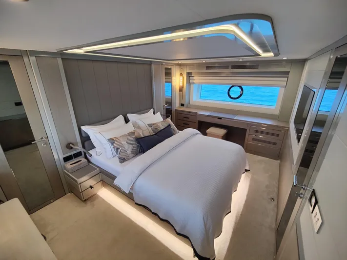  Yacht Photos Pics Luxurious bedroom interior of 2023 Sirena 68 yacht with ocean view window.