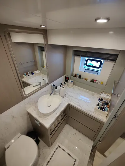  Yacht Photos Pics Luxurious bathroom in 2023 Sirena 68 yacht with modern fixtures and elegant design.