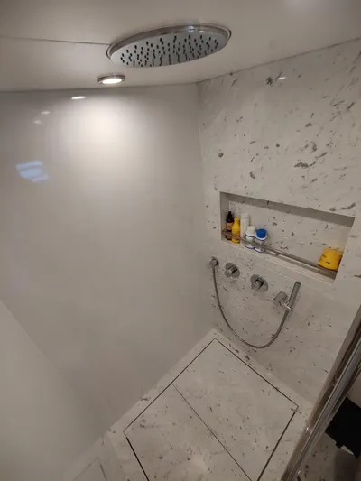  Yacht Photos Pics Luxurious marble shower in 2023 Sirena 68 yacht with modern fixtures.