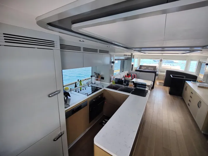  Yacht Photos Pics Luxurious interior of 2023 Sirena 68 yacht with modern kitchen and ocean view.