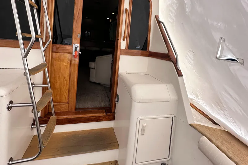 Saylor Moon Yacht Photos Pics 1990 Ocean Yachts 48 Super Sport interior with wooden door and stairs.