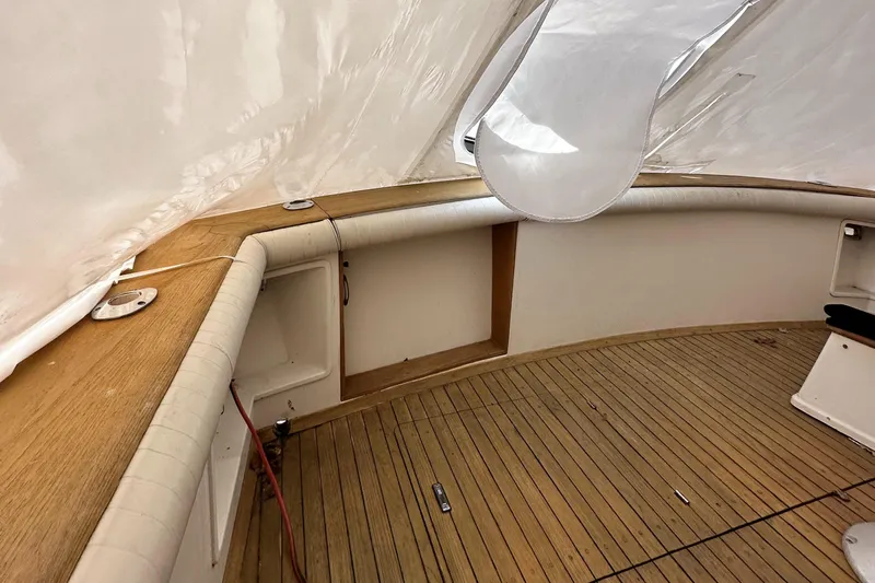 Saylor Moon Yacht Photos Pics 1990 Ocean Yachts 48 Super Sport interior with wooden deck and white upholstery.