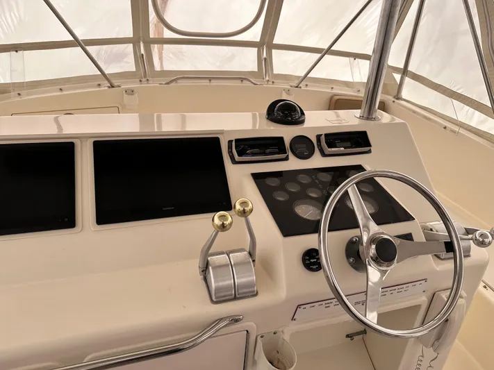 Saylor Moon Yacht Photos Pics 1990 Ocean Yachts 48 Super Sport helm with steering wheel and control panels.