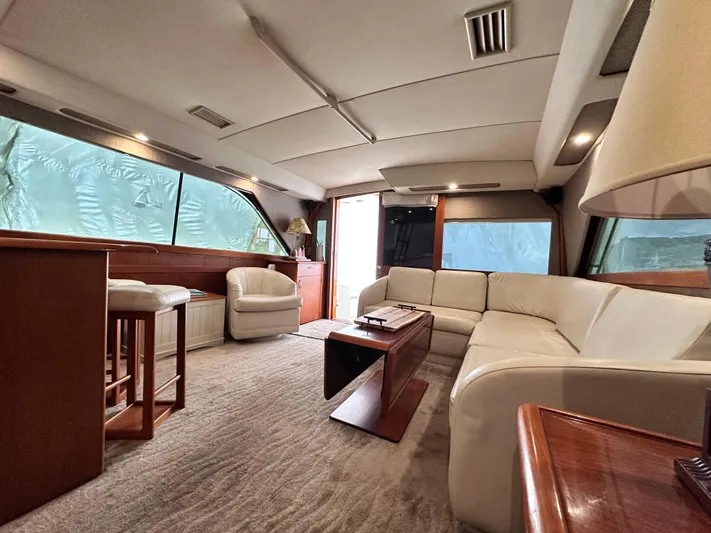 Saylor Moon Yacht Photos Pics Luxurious interior of a 1990 Ocean Yachts 48 Super Sport with elegant seating and wooden accents.