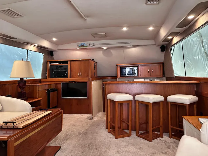 Saylor Moon Yacht Photos Pics Luxurious interior of 1990 Ocean Yachts 48 Super Sport with wood cabinetry and seating.