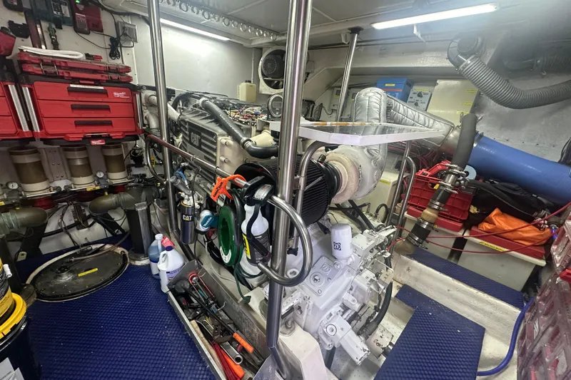 Patrona Yacht Photos Pics Engine room of a 2000 Mikelson 61 Sportfisher with organized tools and equipment.